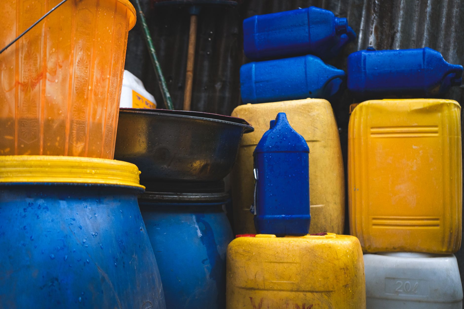 Stackable blue Water Brick containers filled with water in a closet